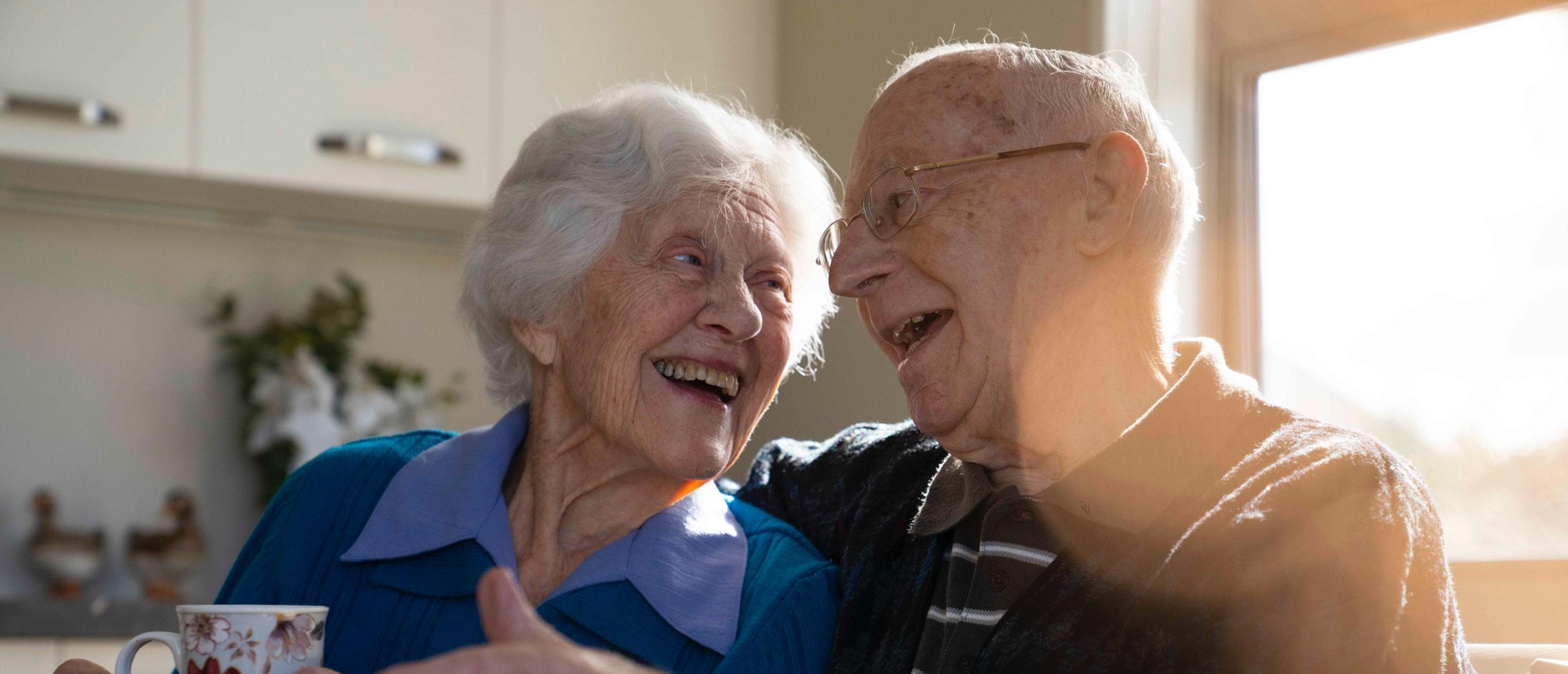 Oceania couple laughing in their Care Suite
